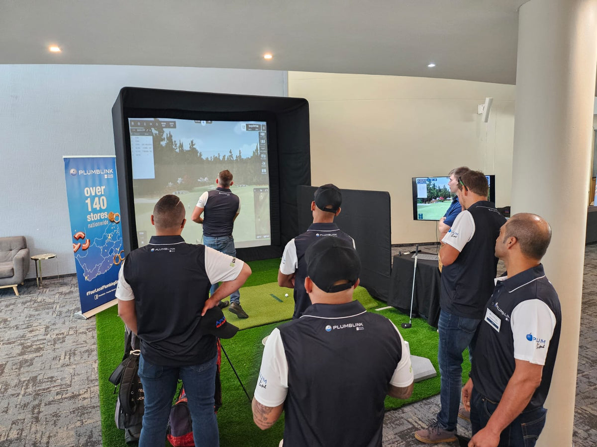 Plumblink corporate event golf simulator activation with indoor enclosure