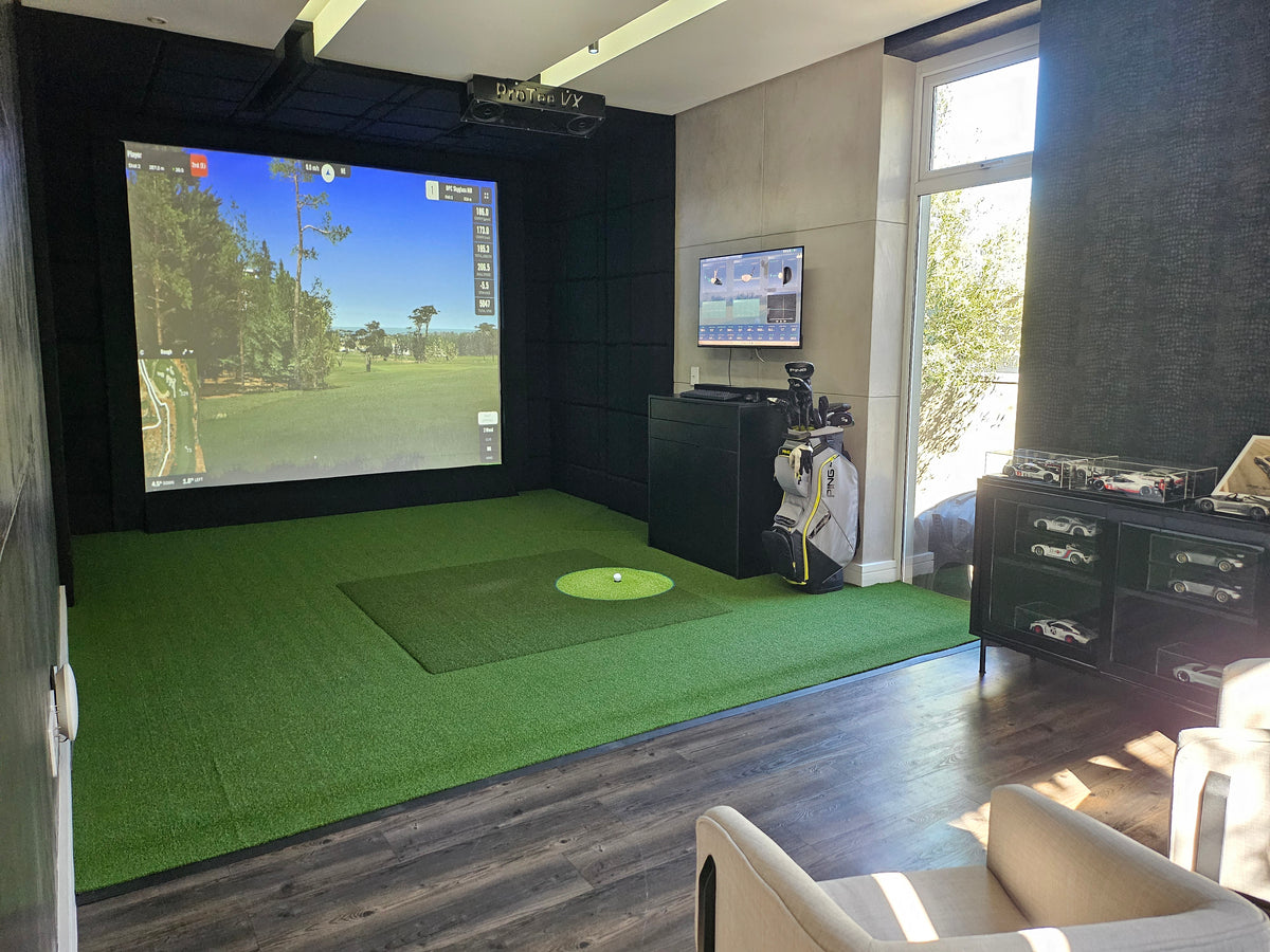 home golf studio with ProTee VX launch monitor, full-swing impact screen, hard wood flooring, and luxury lounge chairs.