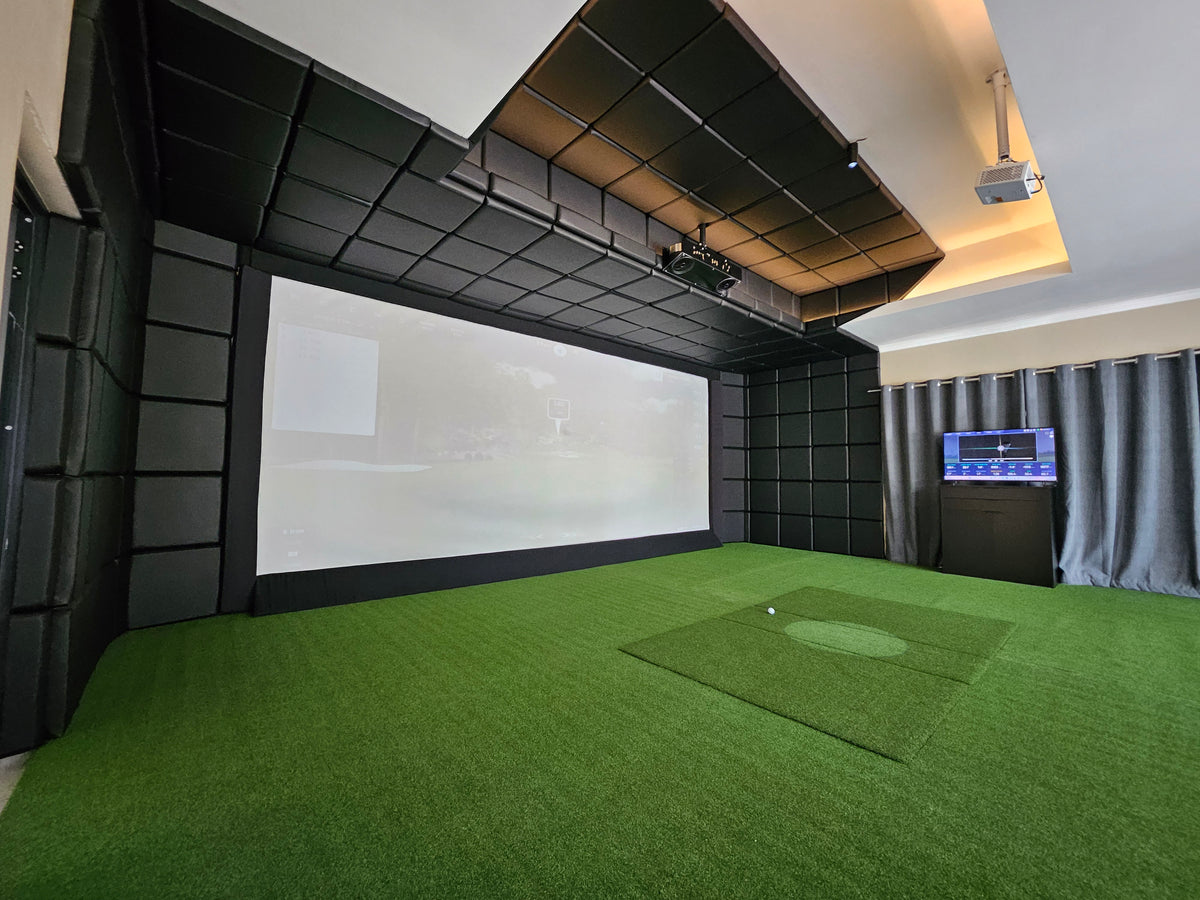 luxury home golf simulator room with vaulted acoustic ceiling, ceiling-mounted projector, large impact screen, and grey side curtains.