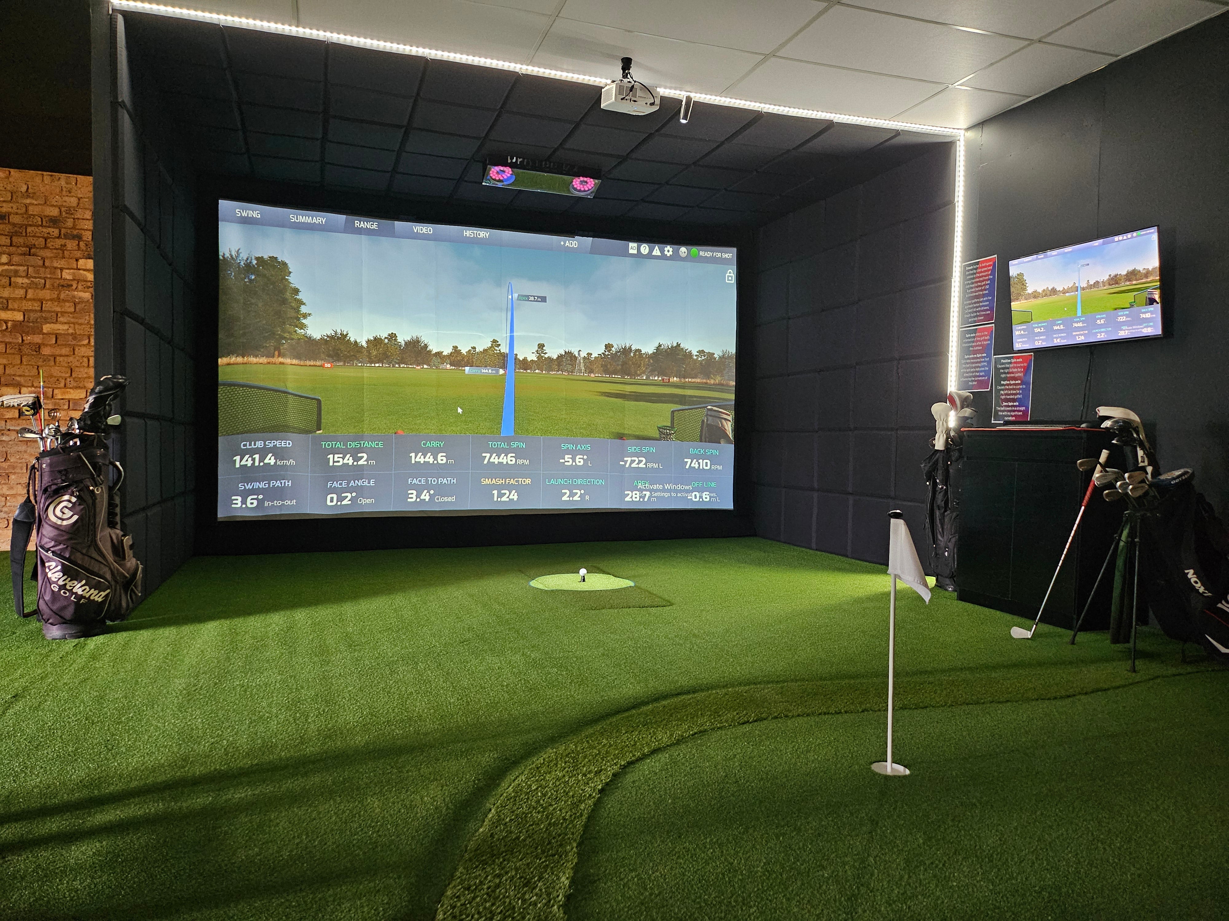 Multi-bay commercial golf simulator facility installation showcasing simulation software, multiple impact screens, and a dedicated practice area.